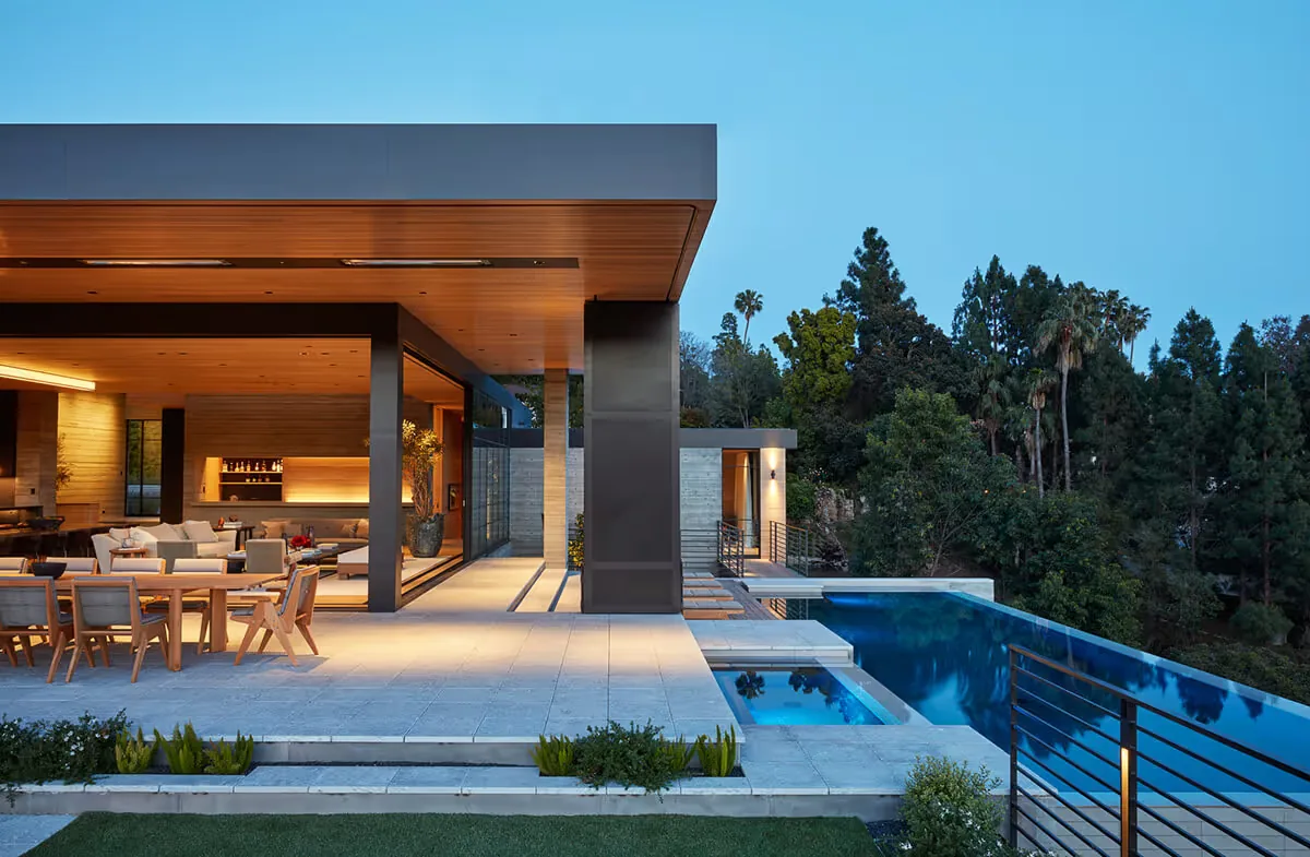 The Sapire Residence features a covered patio and a cantilevered-edge rectangular pool surrounded by a modern outdoor living space.