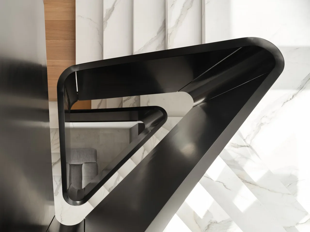 Overhead perspective of a sleek black metal staircase with marble steps and a seating area below.