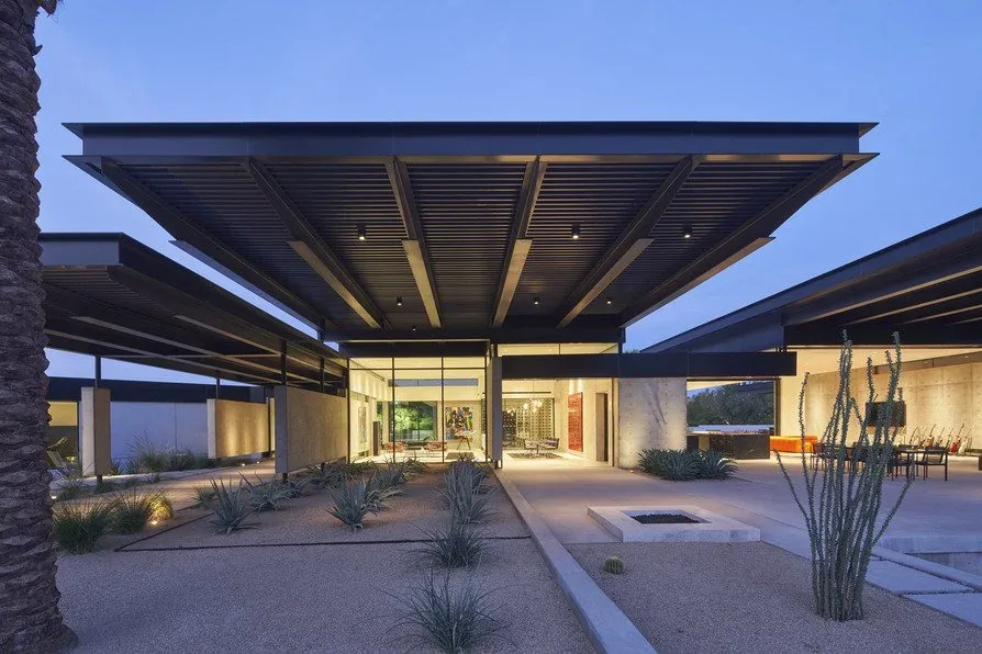 Camelback Residence features a flat roof with wooden slat shading and desert landscaping at the exterior front area.