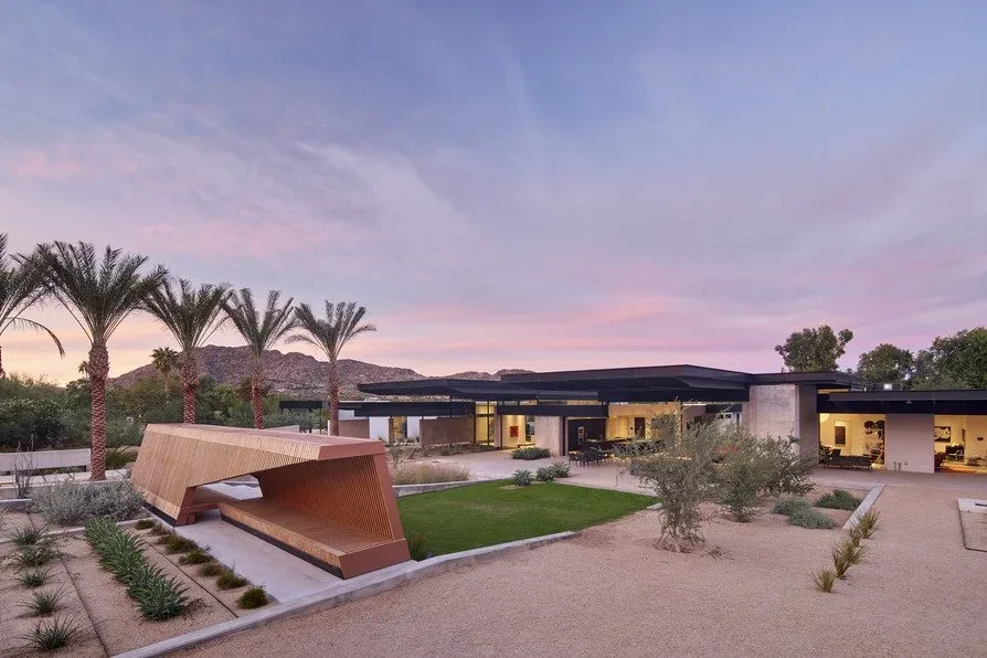 Camelback Residence features a modern flat-roofed design with desert landscaping and mountain views at dusk.