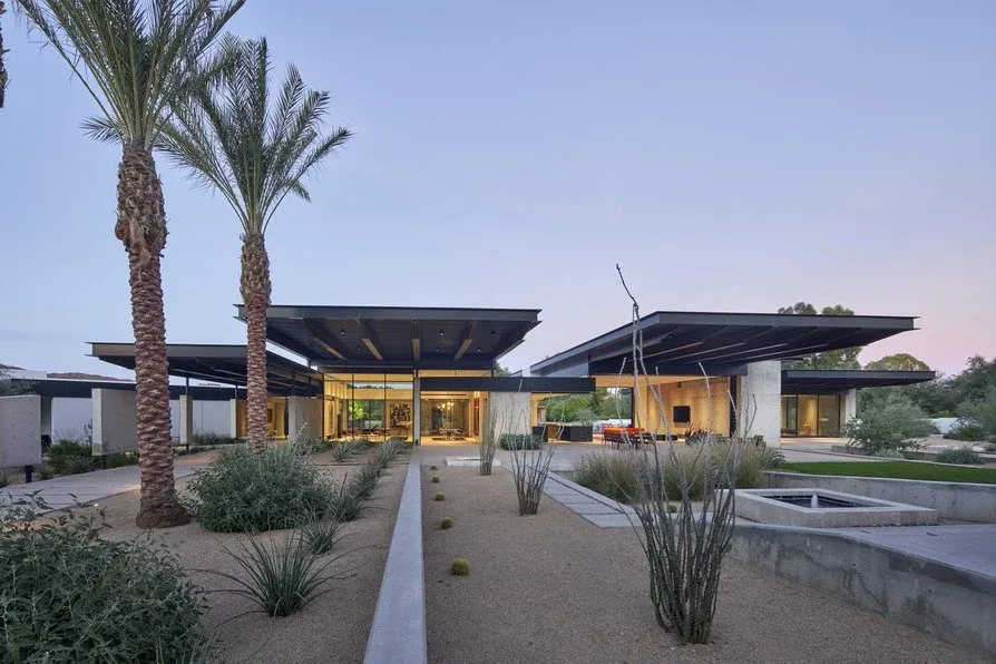 The Camelback Residence by BA Collective features flat roofs and floor-to-ceiling glazing within a desert landscape.