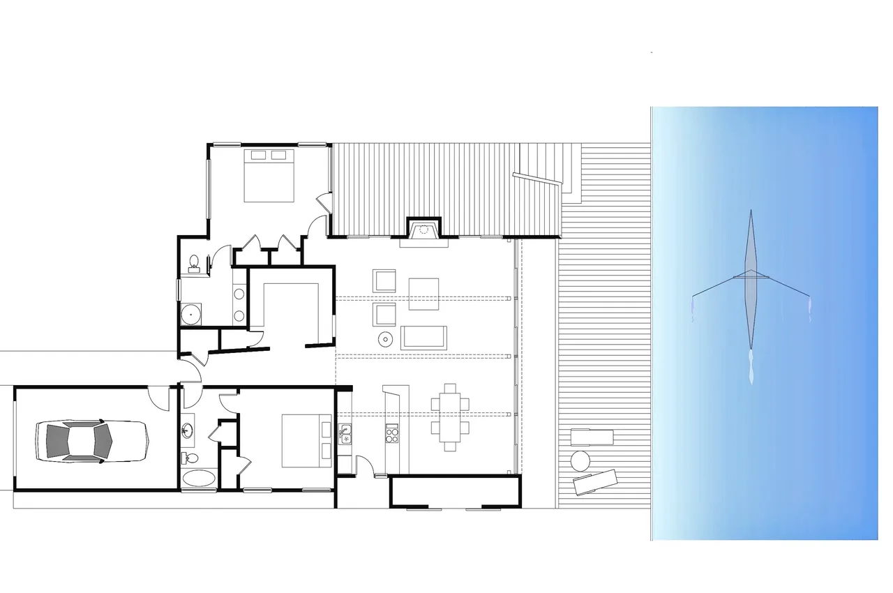 Floor plan of the Sail Loft House showing two bedrooms, two bathrooms, garage, living and dining areas, and deck by the water.
