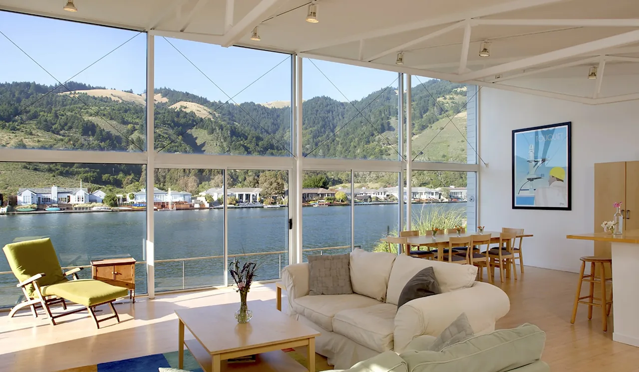 Sail Loft House living space with floor-to-ceiling glazing offering waterfront views and natural light