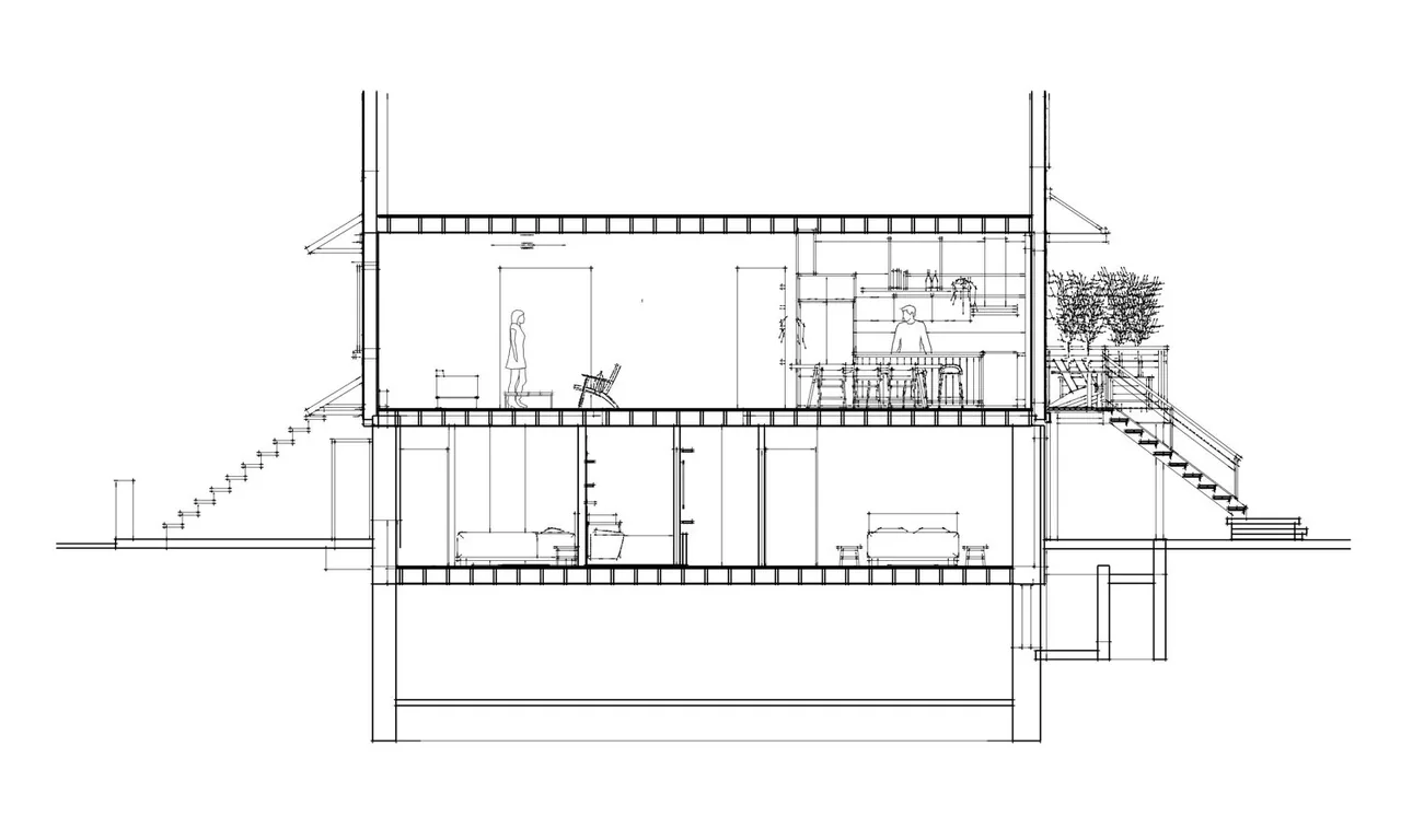 Section view of Brooklyn Townhouse Renovation illustrating interior spaces, staircases, and outdoor deck with vegetation and railing.