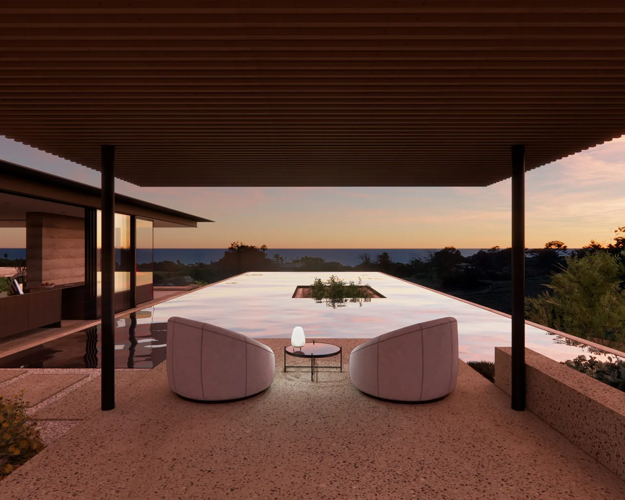 Patio seating area facing an infinity pool with ocean view at sunset.