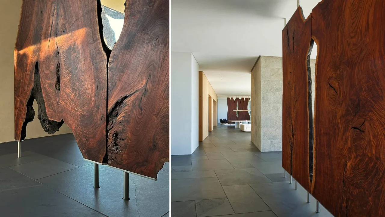 Hallway inside the Dogleg Residence featuring large natural wood panels and slate tile flooring.