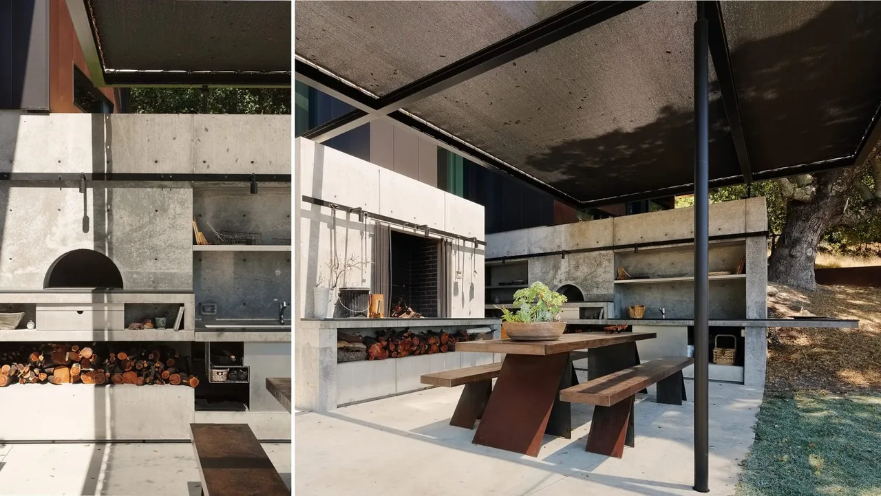 Concrete outdoor kitchen with built-in grill and sink beside a wooden picnic table under a shaded canopy.