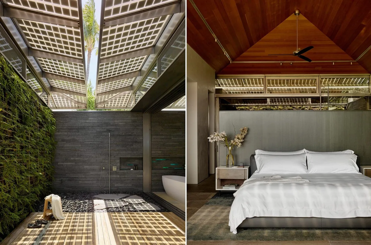 Bedroom with vaulted wood ceiling and connected open-air shower with vertical garden and photovoltaic panels overhead.