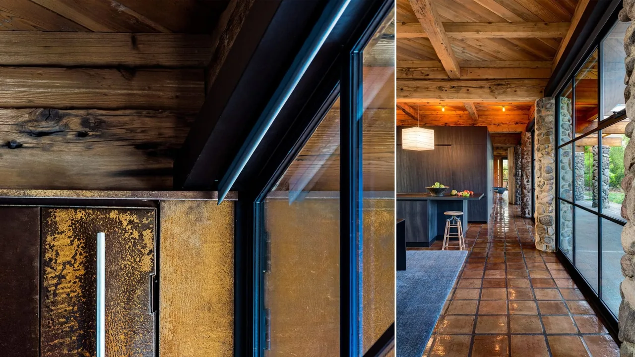 The Napa Residence features a corridor lined with stone columns, black metal window frames, and exposed wooden beams.