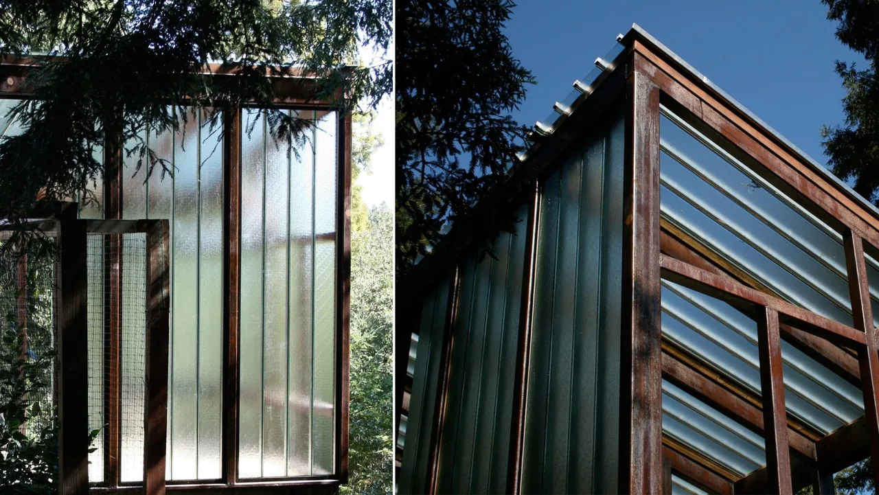 The Lundberg/Breuer Cabin features vertical translucent glass panels in a dark metal frame on its exterior walls.