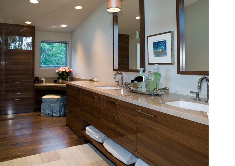 Double vanity bathroom with wood cabinetry and neutral walls in the Leschi Lake House project.