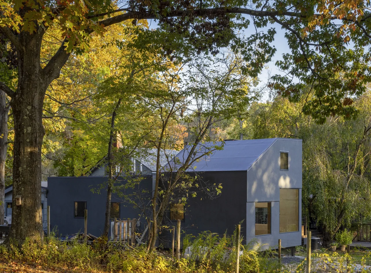 The Catskill Creek Addition features a two-story modern extension with an asymmetrical roof and large rectangular windows.