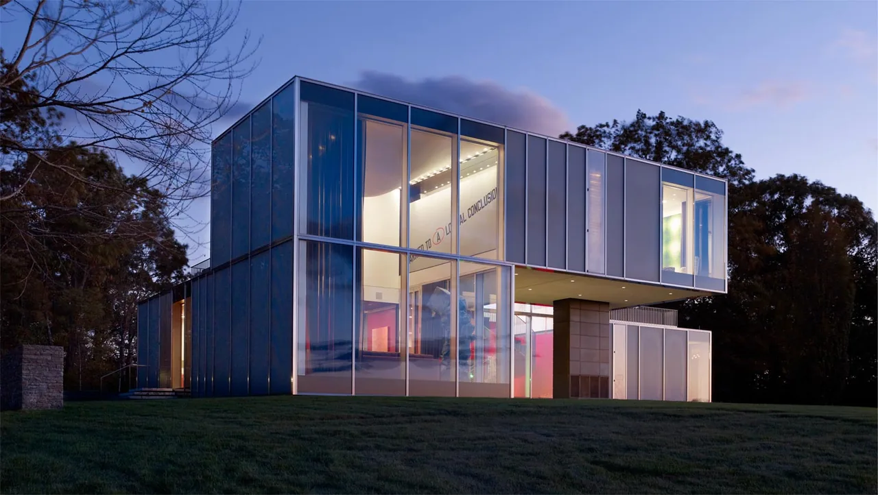 The Dutchess County Residence Main House by Allied Works Architecture features large glass panels and a cantilevered upper story.
