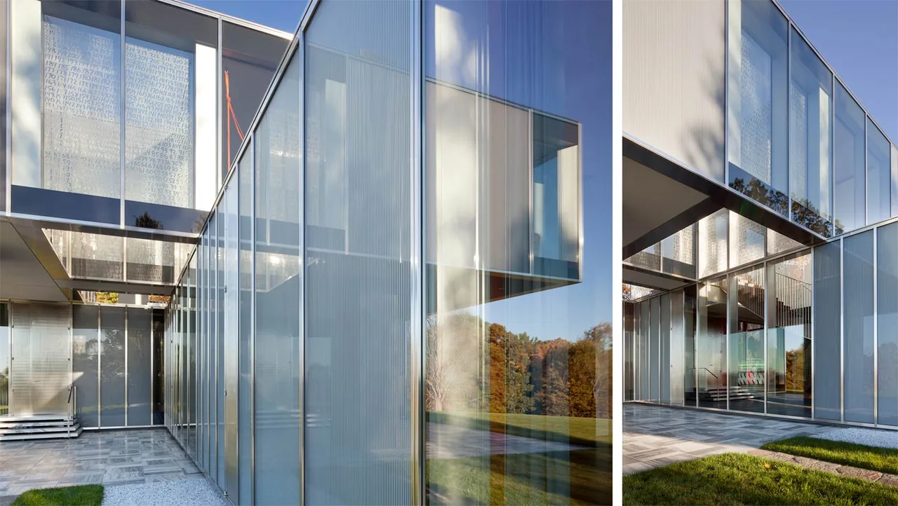 This image shows the exterior of the Dutchess County Residence Main House with extensive glass and metal construction.