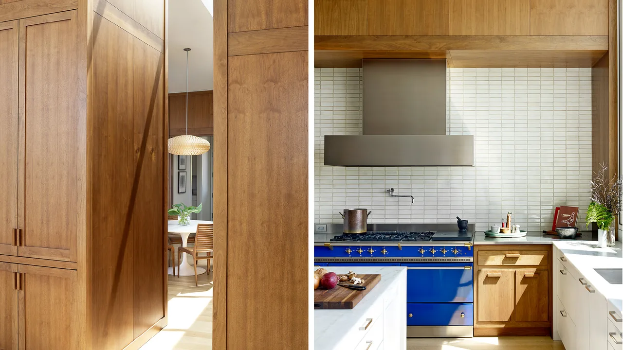 Kitchen at Portland Heights Residence with wood cabinetry and a blue stove by Allied Works Architecture.