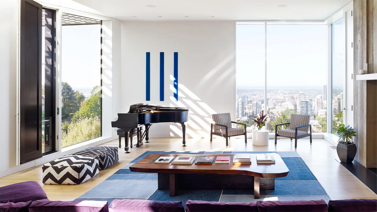 Living room in the Portland Heights Residence with large windows overlooking the city and a grand piano.