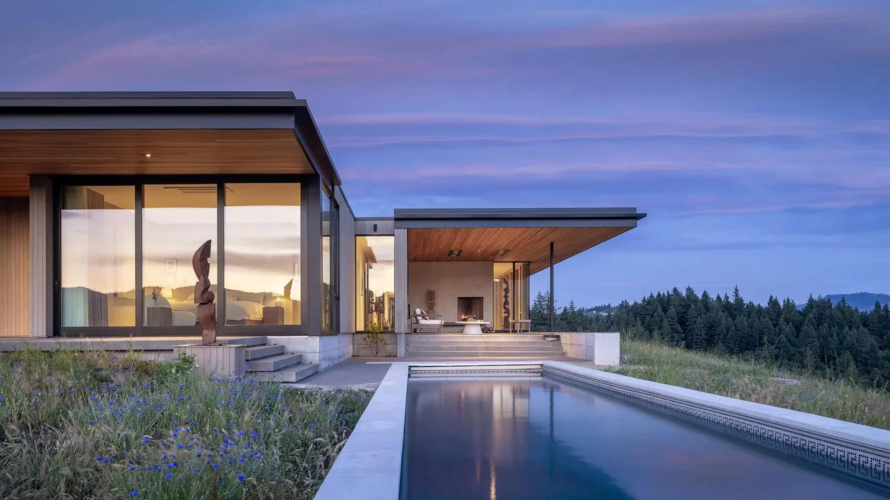 Modern residence with pool, wood soffit, large glass windows, and outdoor seating area with fireplace.