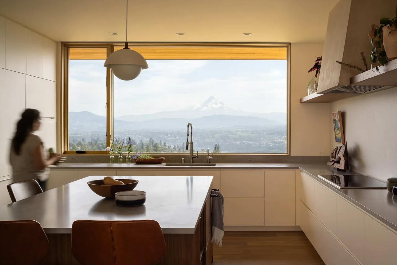 Kitchen with a large window showcasing mountain views in the Bald Mountain Residence by Scott | Edwards Architecture.