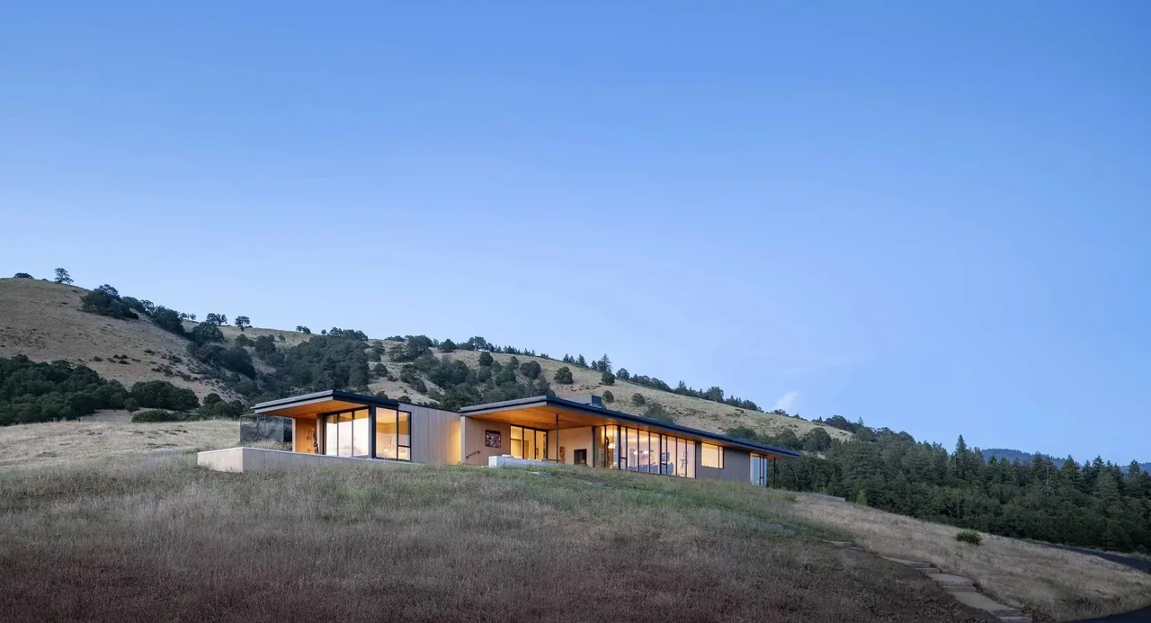 Bald Mountain Residence features a low-profile modern design with extensive glazing and a hilltop setting.