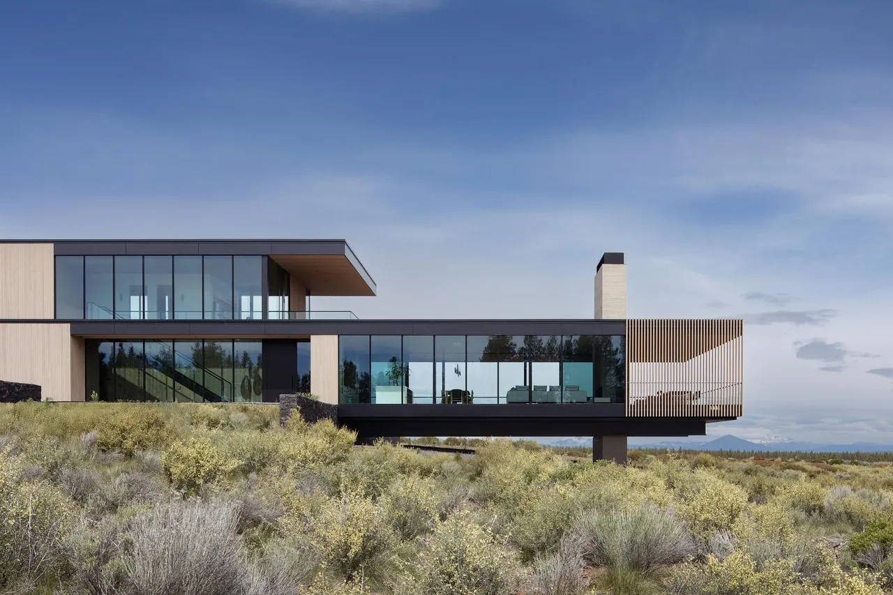 The Expanse features a modern flat roof home with floor-to-ceiling glazing and a cantilever over natural terrain.