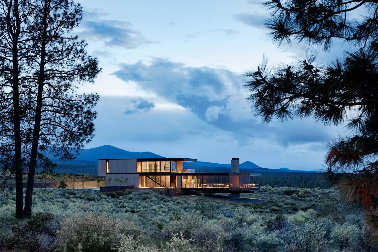 The Expanse features a modern design with large glass panels and cantilevered sections blending into the surrounding landscape.