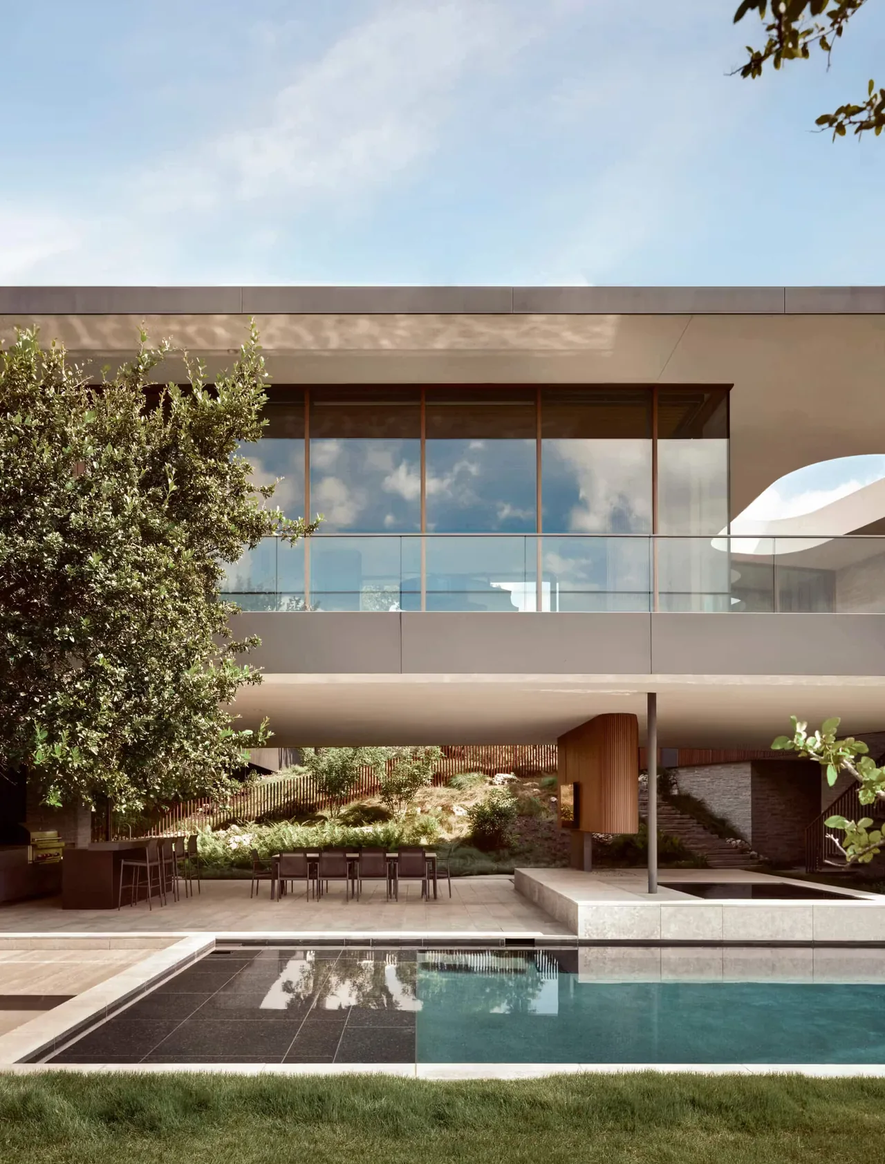 City Park Residence by Alterstudio features a cantilevered upper level with floor-to-ceiling windows and an outdoor pool area.