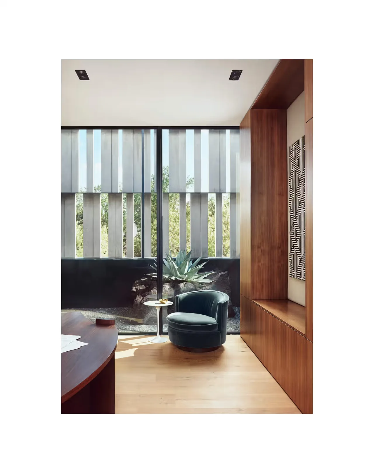 Living area corner with floor-to-ceiling large vertical wood slat windows and wood paneling at Highland Park Residence.