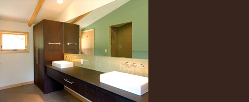 Hillside House bathroom features double wall-mounted faucets and rectangular sinks.