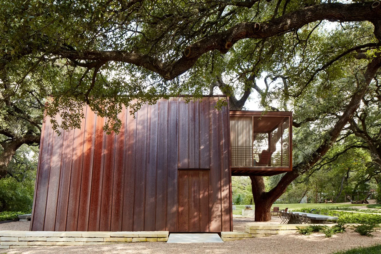 The Jewell Box project features a compact rusted metal exterior with a cantilevered enclosed glass space by Mell Lawrence Architects.