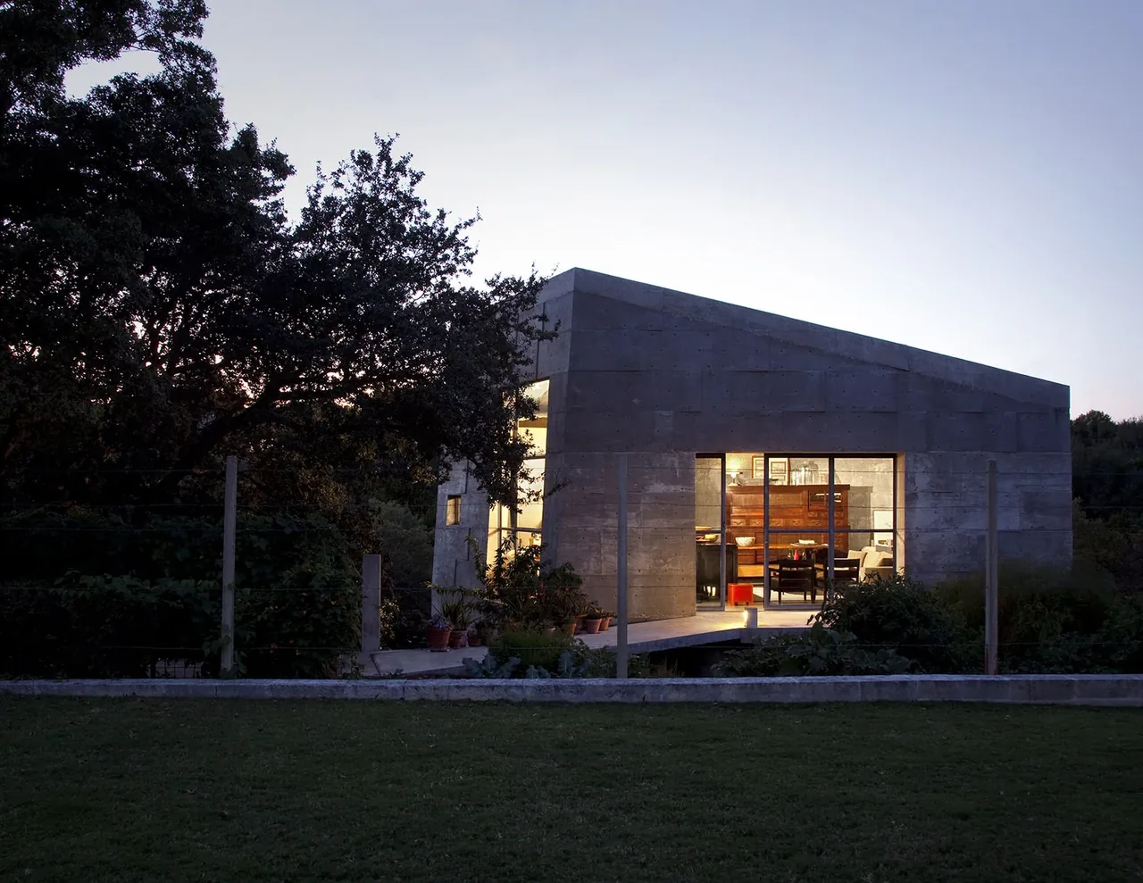 Concrete Studio Gallery by Mell Lawrence Architects in Austin features textured concrete walls and large glass windows.