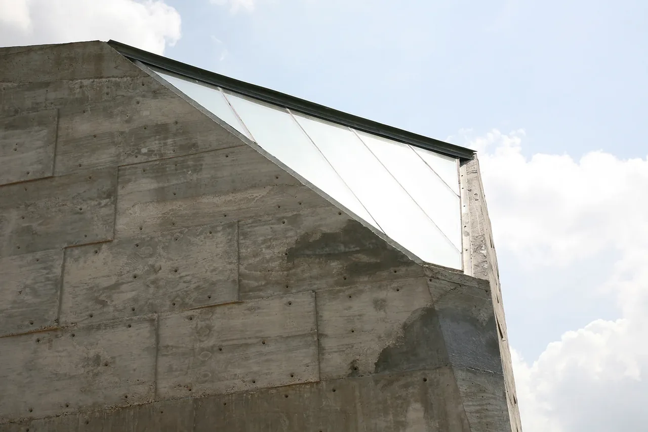 The Concrete Studio Gallery features a textured concrete wall with a large triangular translucent window detail.