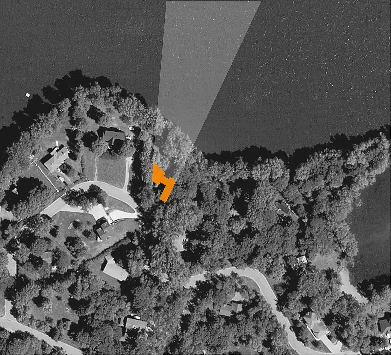 Aerial image highlights the Farquar Lake Residence by ALTUS Architecture + Design near the lakeshore.