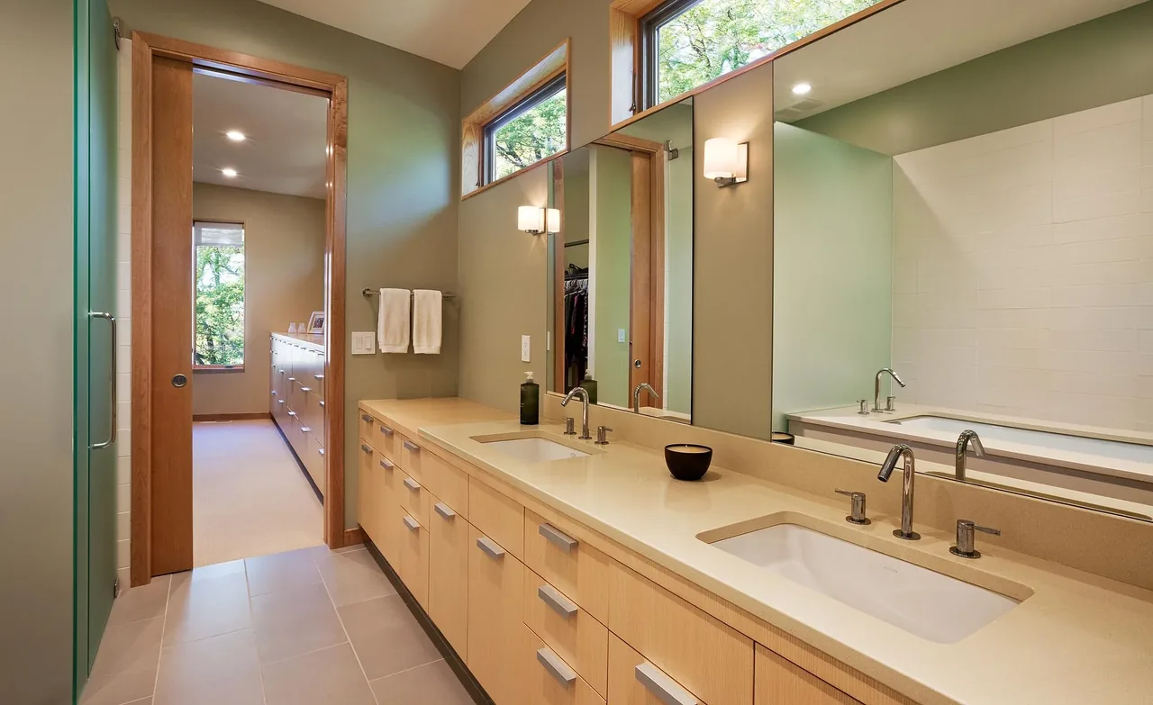 Bathroom interior with double undermount sinks and a large mirror in Farquar Lake Residence by ALTUS Architecture + Design.