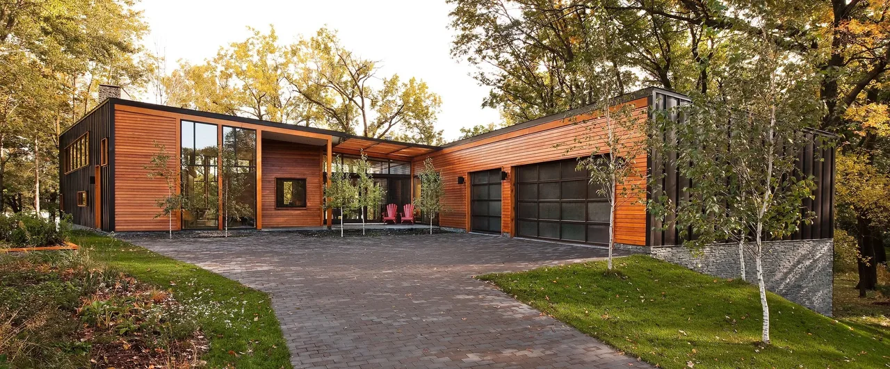 Farquar Lake Residence features horizontal wood siding and large black-framed windows in a modern style by ALTUS Architecture + Design.