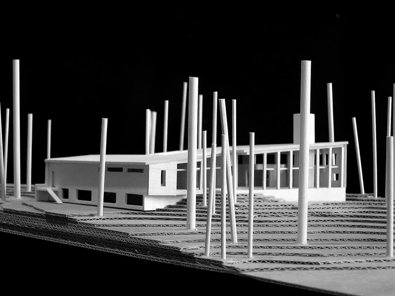Architectural model of the Farquar Lake Residence showing a modern flat roof house on a terraced site model with vertical posts.