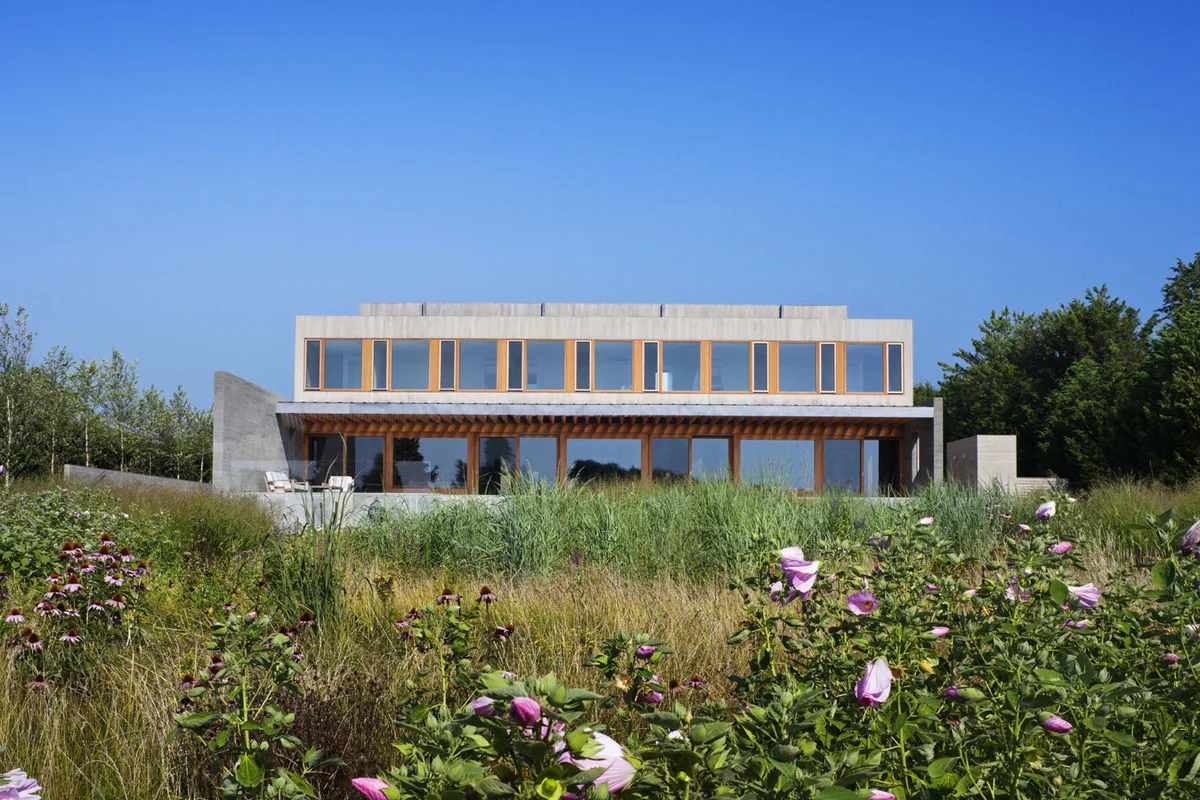 The Watermill Residence features a linear facade with large rectangular windows and a flat roof.