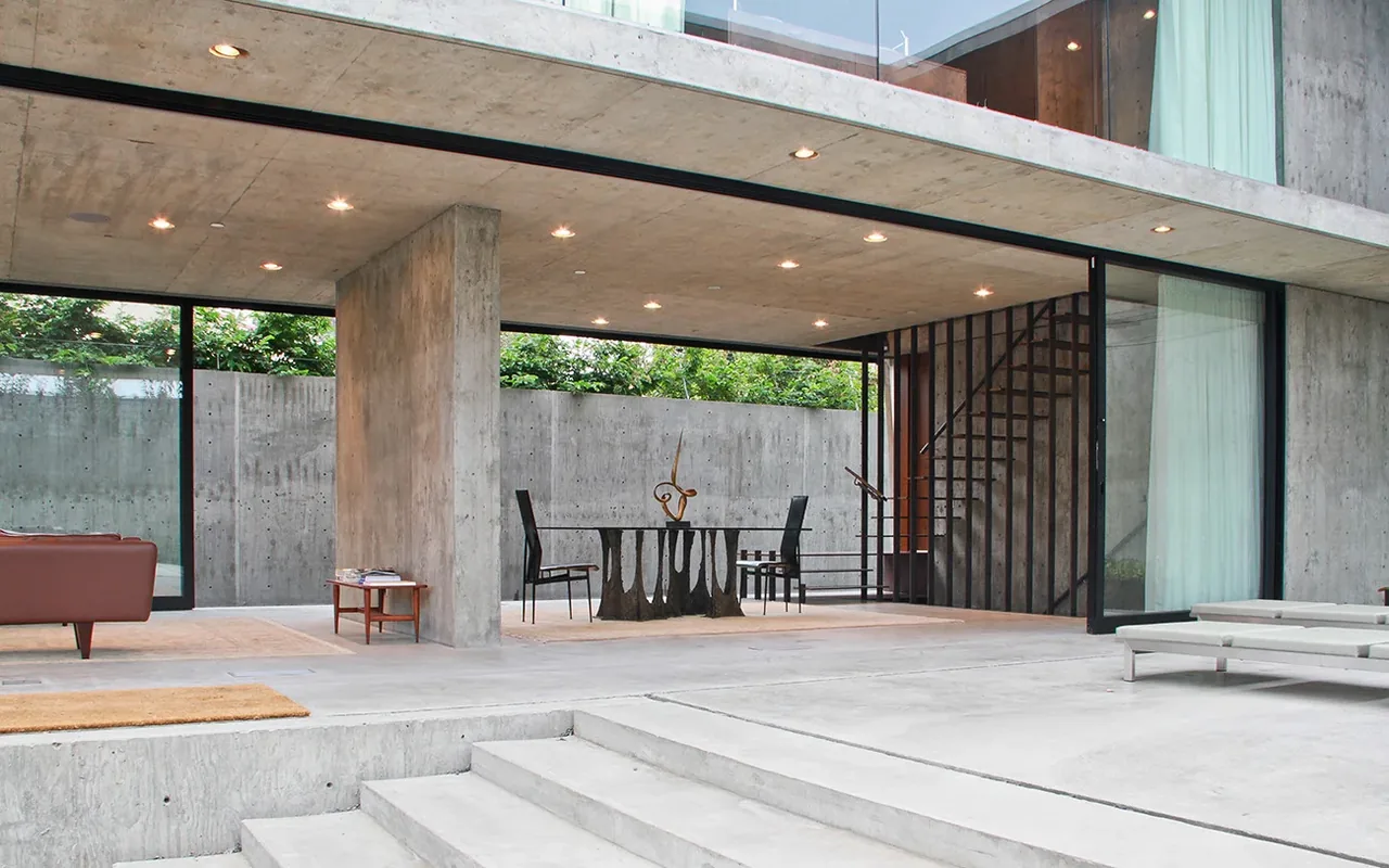 The Cresta features an open concrete patio area with recessed lighting and minimal outdoor furnishings.