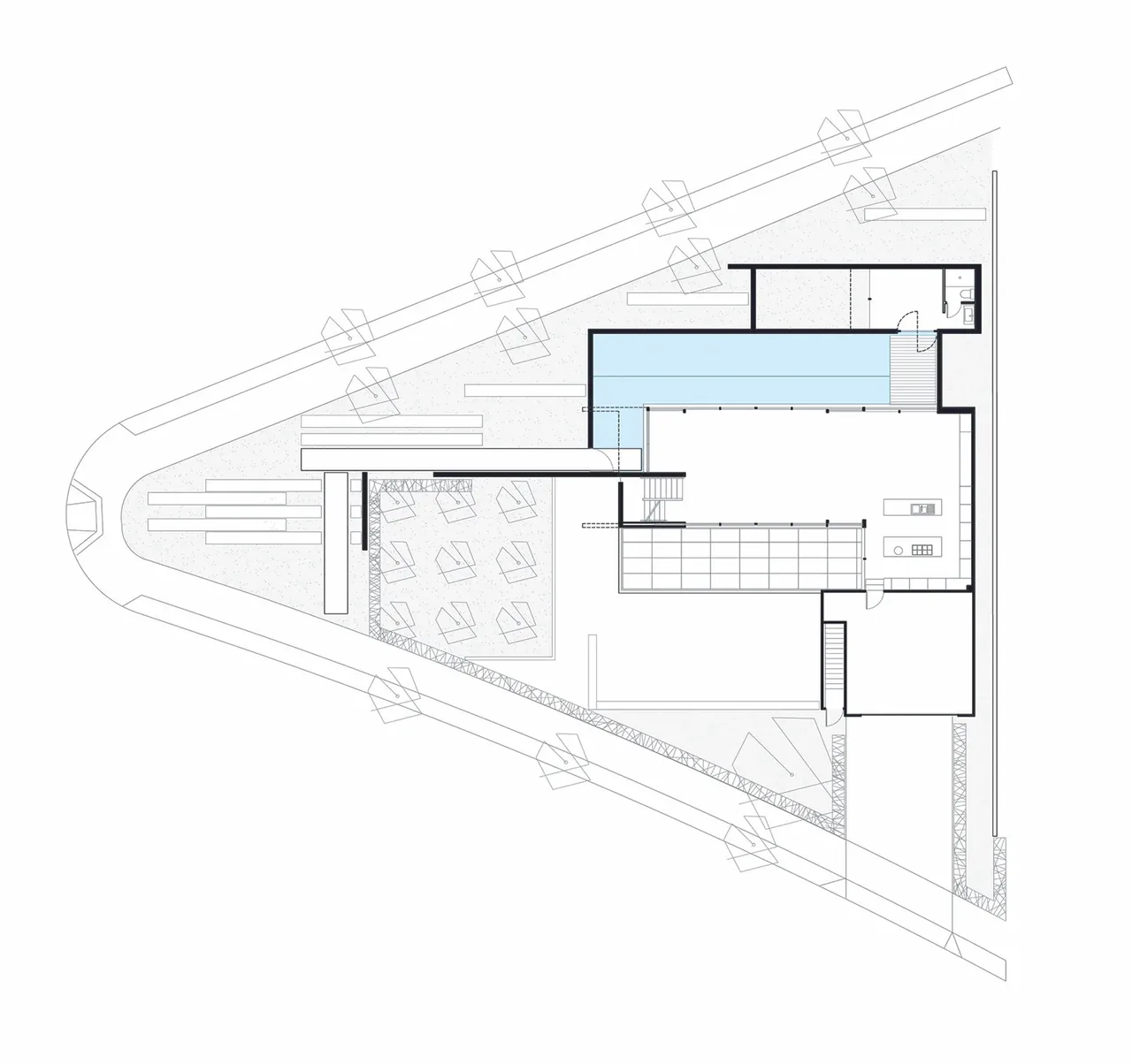 Floor plan showing a triangular lot with a house, pool, patio, and interior kitchen island.