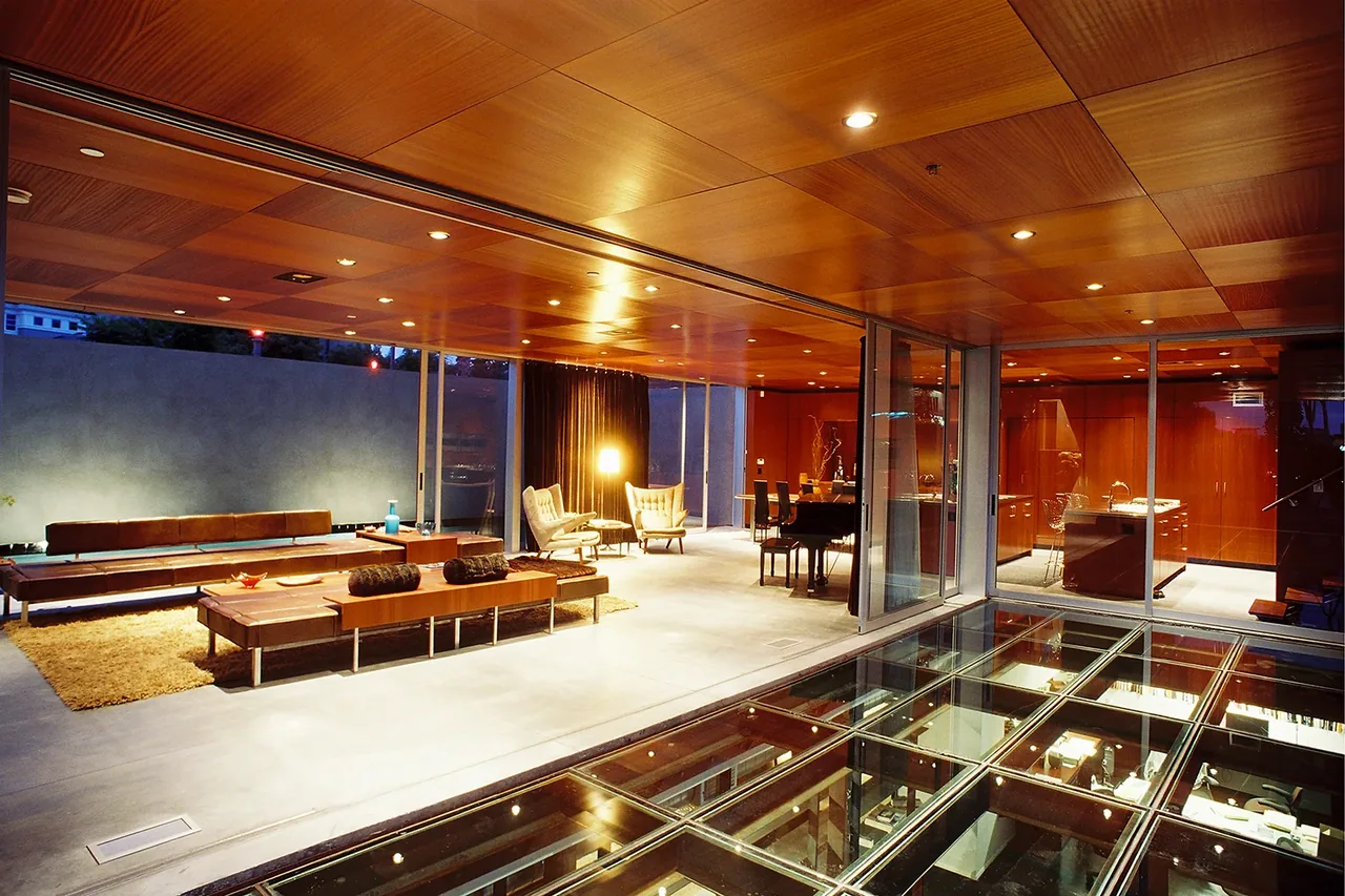 The Prospect features an open-plan living space with wood-paneled ceiling and polished concrete floor, designed by Jonathan Segal.