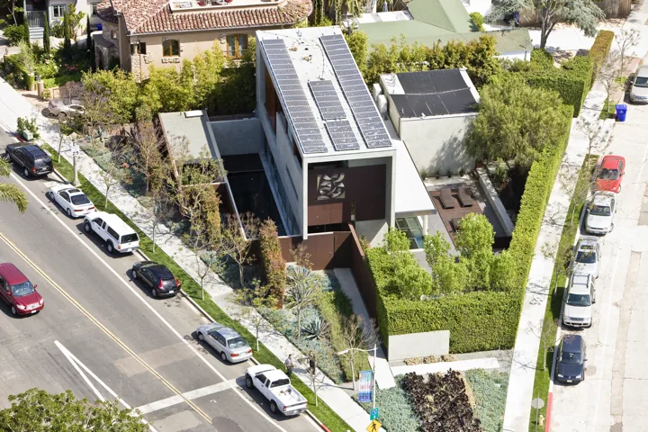 The Prospect features a narrow, solar-paneled modern home with green landscaping and privacy hedges.