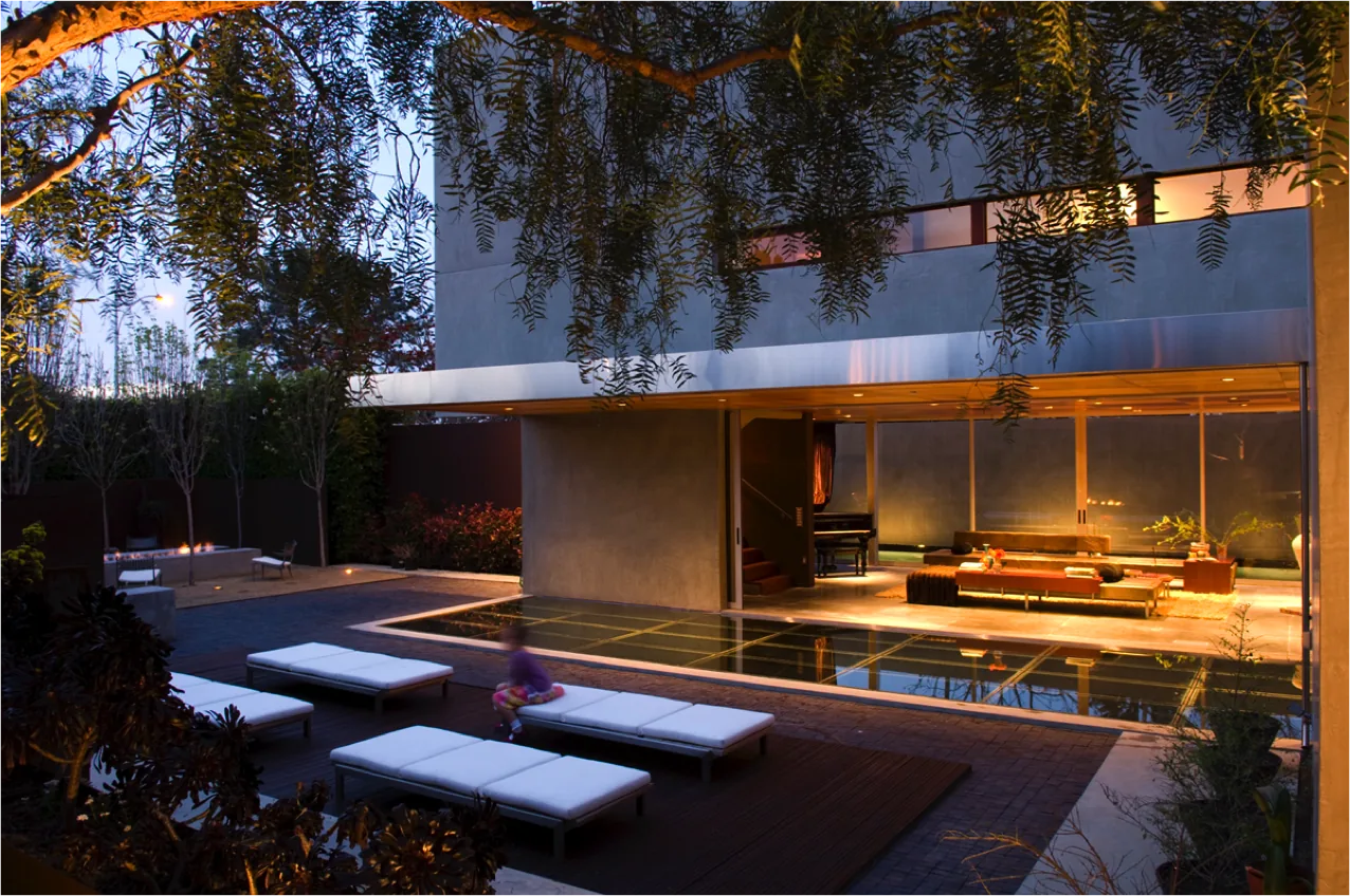 The Prospect features a reflecting pool and outdoor seating adjacent to a modern living space with floor-to-ceiling glass doors.