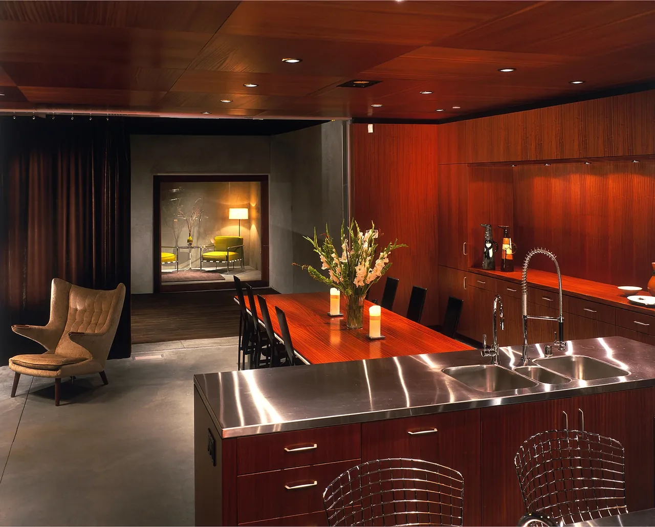 The Prospect features a kitchen and dining space with wood paneling and concrete flooring, designed by Jonathan Segal.