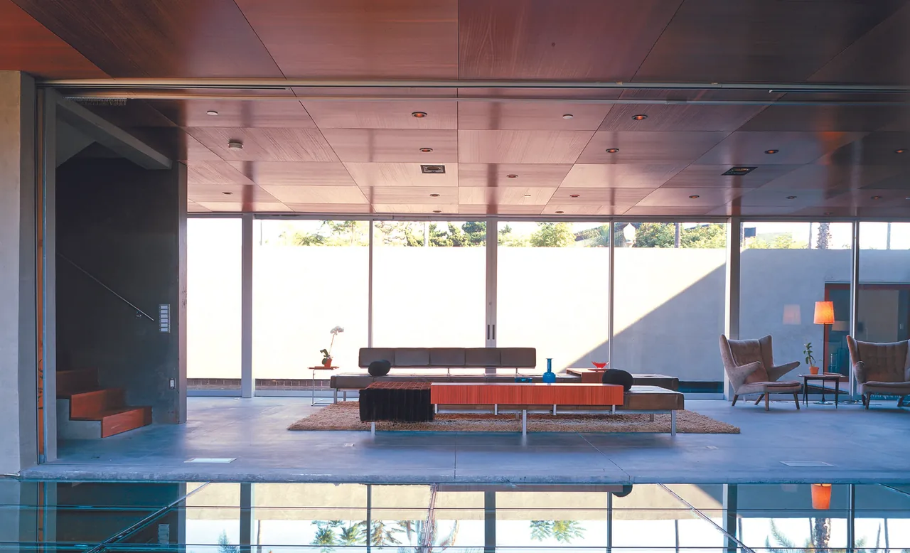The Prospect's living area features floor-to-ceiling glazing and a wood-paneled ceiling, reflecting the modern style.