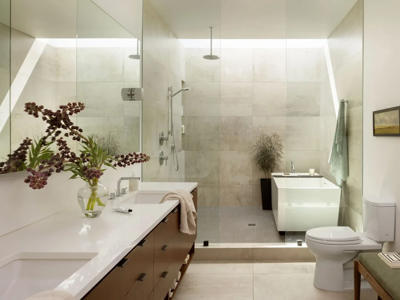 Modern bathroom featuring a walk-in shower with glass enclosure and a freestanding white bathtub.