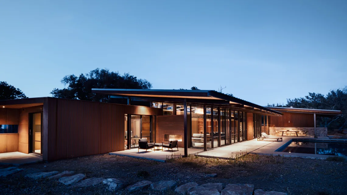 Modern HOUSE FOR A NEW BEGINNING by Nielsen Schuh Architects features expansive glass walls and flat roof overlooking a natural hillside in San Francisco.