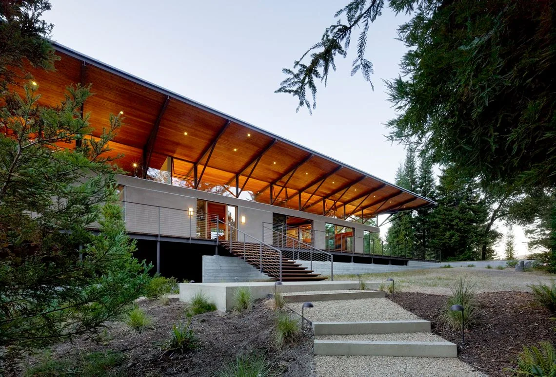 Sonoma Mountain House features an elevated structure with a deep overhanging gable roof and wide concrete steps.