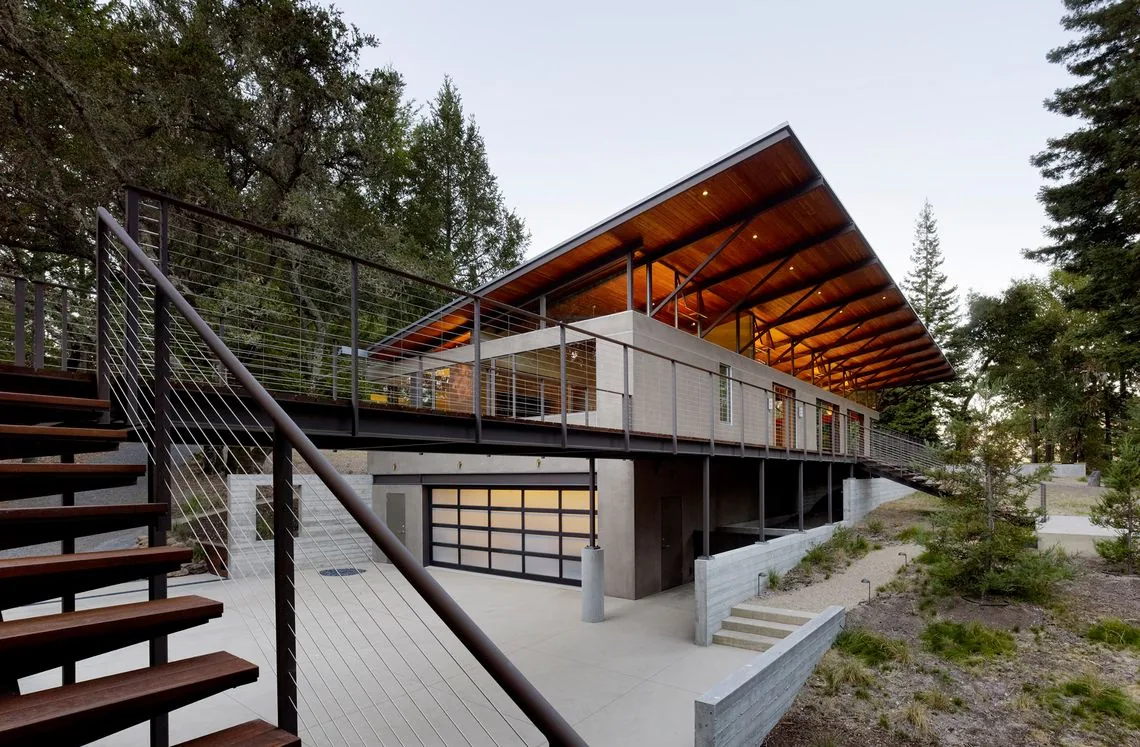 Sonoma Mountain House features an elevated structure with a large overhanging roof and cable railing staircase.