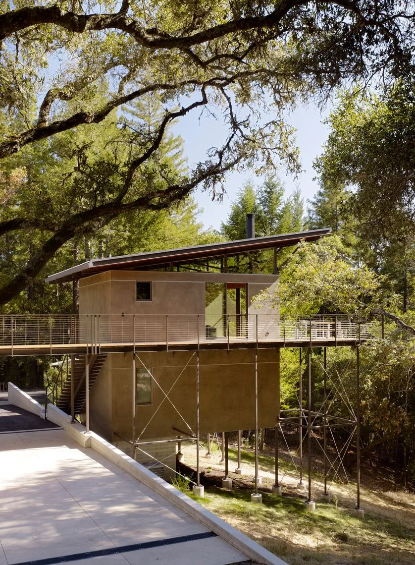 Sonoma Mountain House features a raised foundation with metal bracing in a forest setting.
