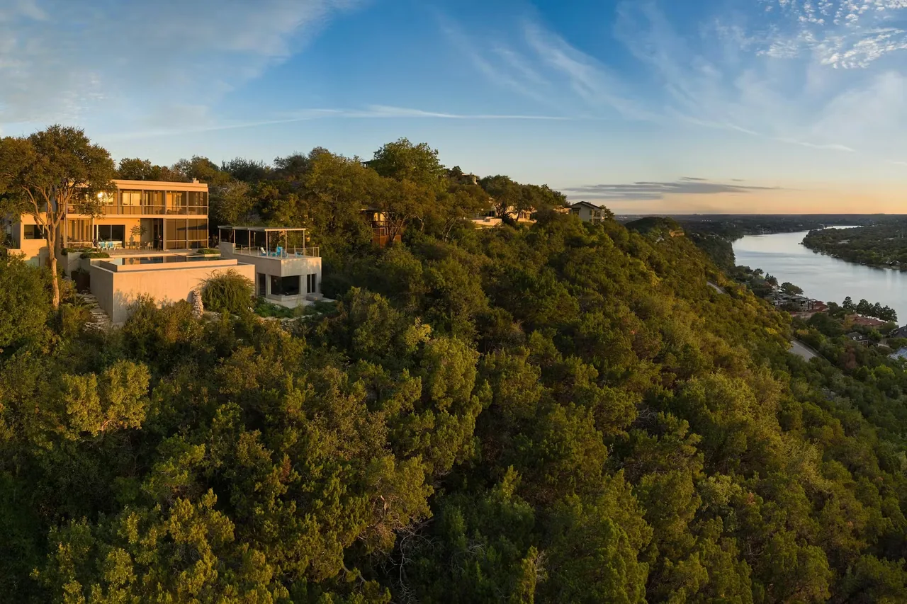 Residence on Mount Barker situated on a heavily treed hillside with expansive river views at sunset.