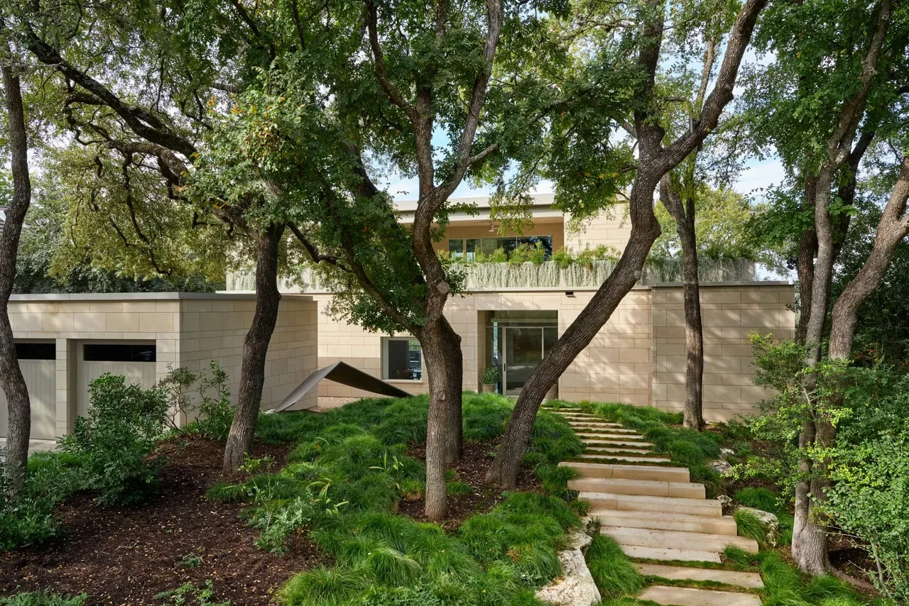 Residence on Mount Barker, a modern house with stone cladding, landscape stairway, and mature trees.